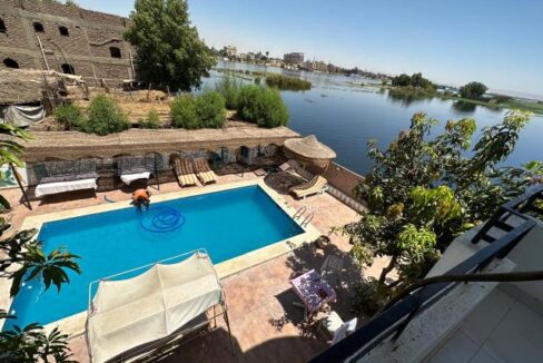 This stunning apartment building features swimming pool and garden with inviting seating areas in Ramla, West Bank Luxor.